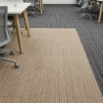 Beige and gray striped ribbed office carpet tiles in a commercial workspace.
