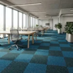 Blue and dark gray checkered loop pile office carpet tile texture in a modern workspace.