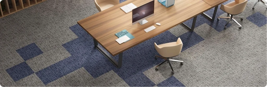 Blue and gray pixelated pattern office carpet tiles installed in a modern workspace.