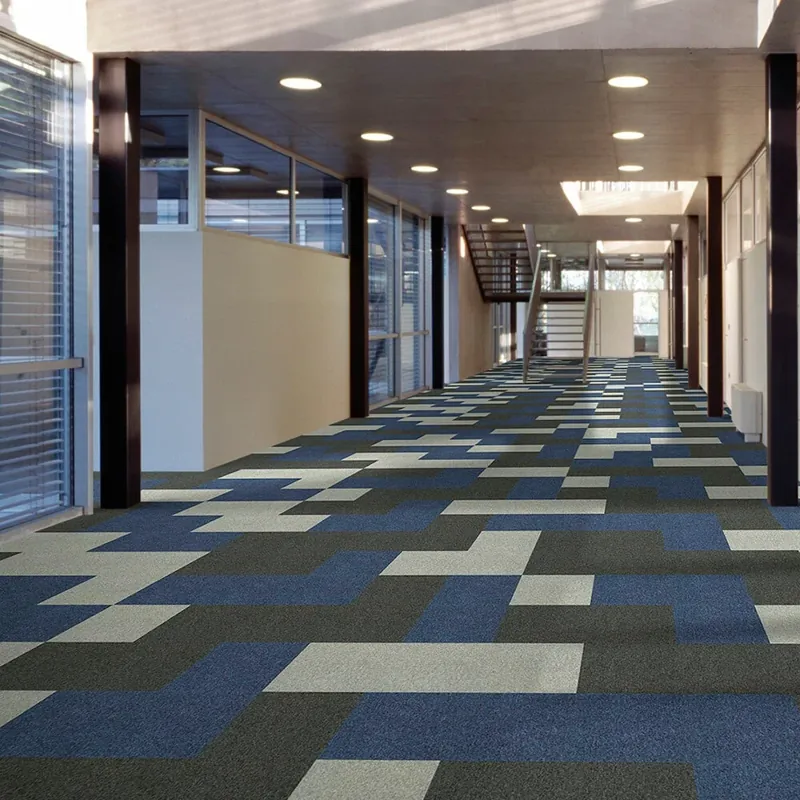 Blue, grey, and white plank carpet tiles in an office hallway.