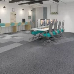Checkered gray office carpet tiles with teal chairs