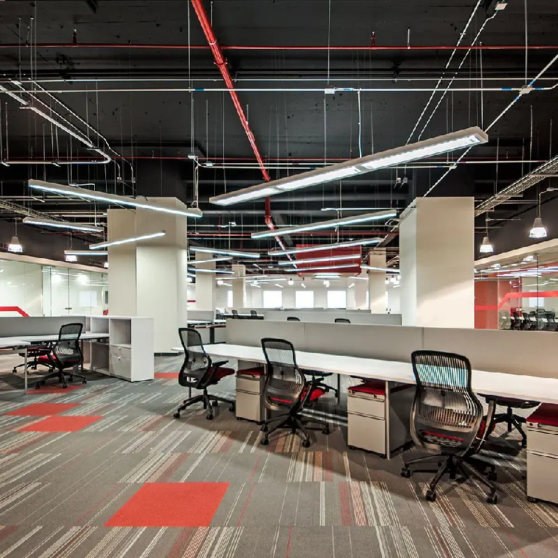 Gray commercial carpet tiles with linear pattern and red accent squares