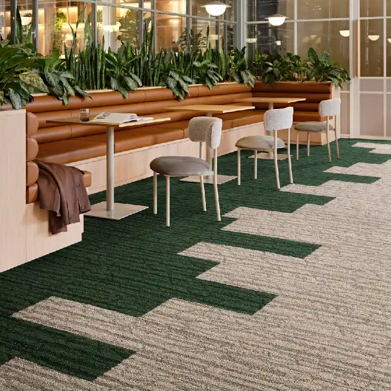 Green and beige carpet tiles in a modern lounge area.