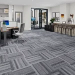 Modern office workspace with grey patterned carpet tiles