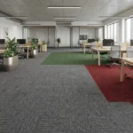 Multicolor patterned ribbed office carpet tiles installed in a modern workspace.