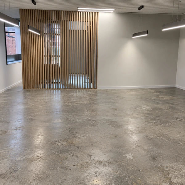 Office interior featuring wooden slat wall & concrete floor