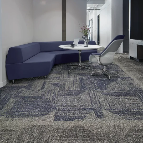Office lounge area with textured dark grey carpet tiles