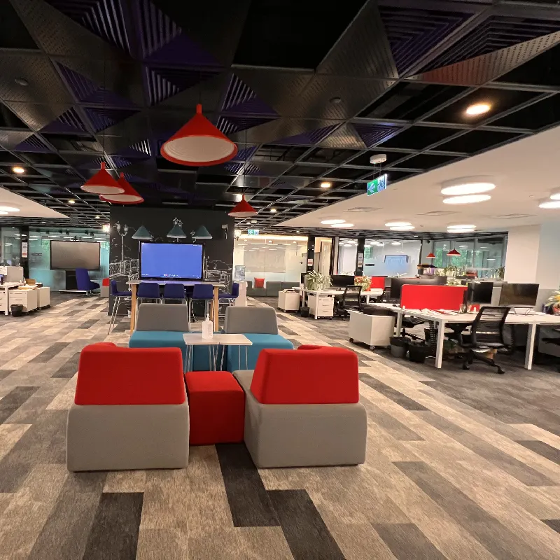 commercial carpet tiles featuring bold red and blue accent blocks in a contemporary office